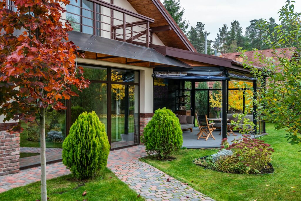 Beautiful landscaped backyard with a modern patio and colorful trees.