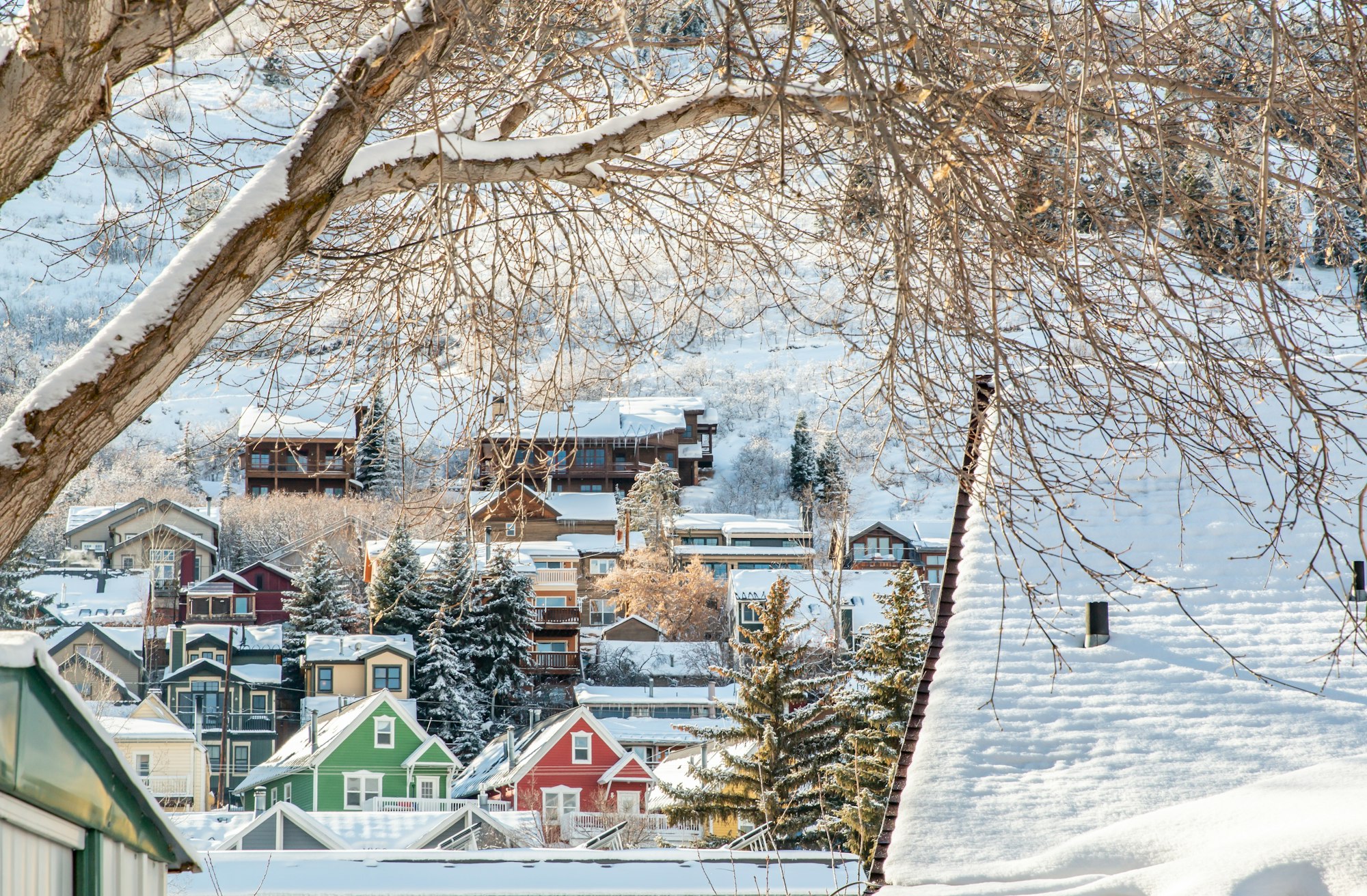 Looking out at the multi colored houses covered with snow in Utah