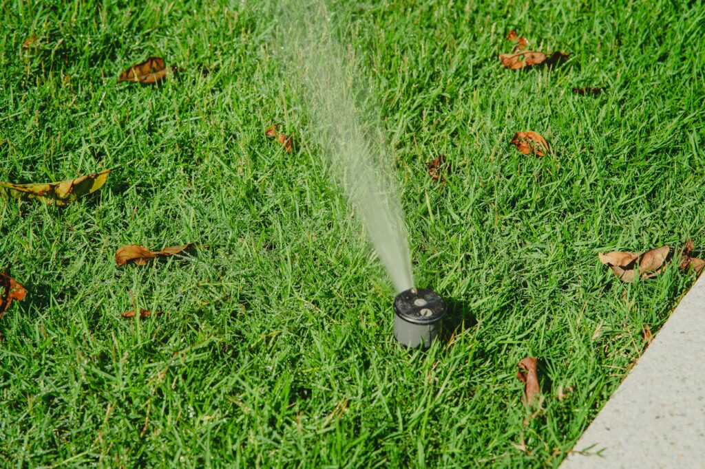 Sprinkler on grass in the garden.